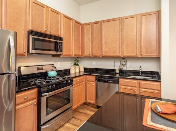 A kitchen with wooden cabinets and stainless steel appliances.