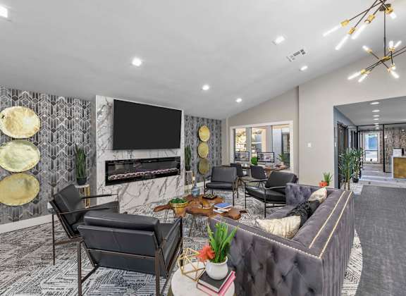 A modern living room with a grey sofa, a coffee table, and a fireplace.