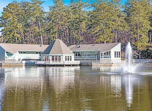 A building with a fountain in front of it.