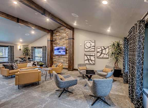A living room with a stone wall and a large window.