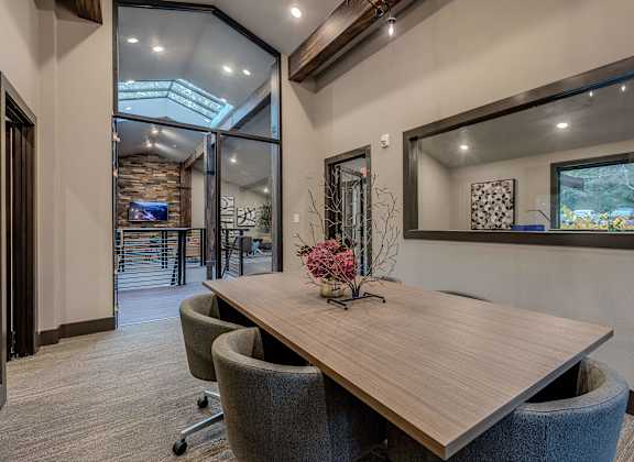 A conference room with a long table and chairs.