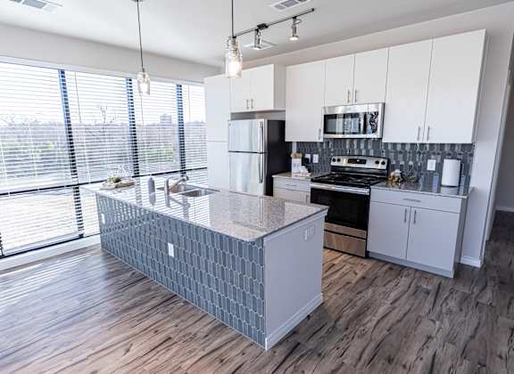 A kitchen with a large island in the middle.