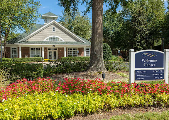 A building with a sign in front that says Welcome Center.