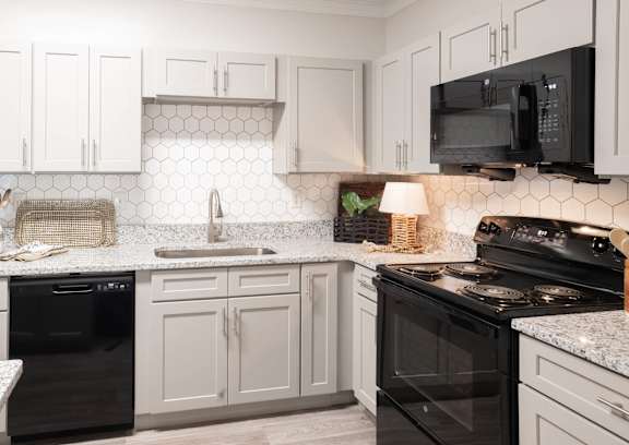 an empty kitchen with granite counter tops and stainless steel appliances at The Ridge at Chenal Valley, Little Rock, Arkansas