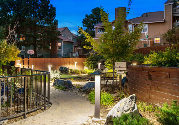 a pathway in a garden with houses in the background at Arcadia Apartments, Centennial, 80112