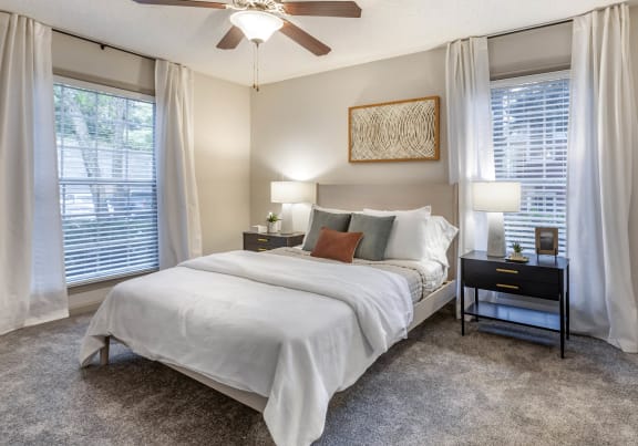 a bedroom with a bed and a geometric wallpaper on the wall at Roswell Village in Roswell, GA