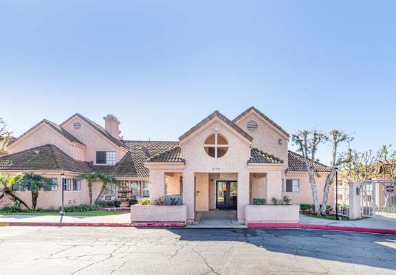 A pink house with a white fence in front. at Whispering Fountains Diamond Bar, Diamond Bar, 91765