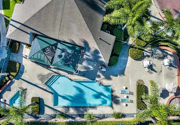 An aerial view of a house with a pool and a patio area. at Whispering Fountains Lakewood, California