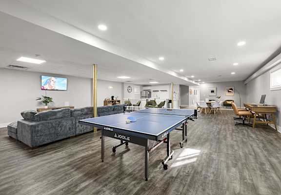 A room with a JOOLA table tennis table in the middle at Gardens at Washington Park in GA, 30314