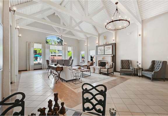 a large living room with chairs and a table