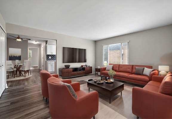 A living room with a red couch and a coffee table.