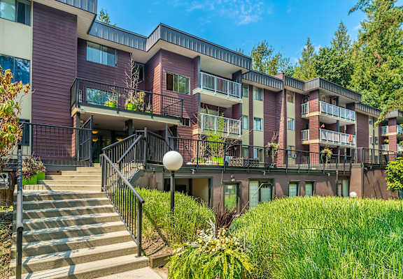 A modern apartment building with a staircase leading to the entrance.