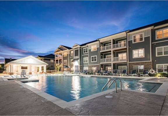 A large swimming pool is surrounded by apartment buildings at Waterleaf at Neely Ferry Apartments, Simpsonville, 29680