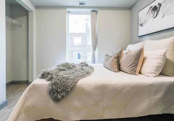 a bedroom with a large bed and a window