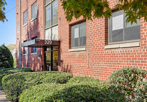 A red brick building with the number 320 on the front.