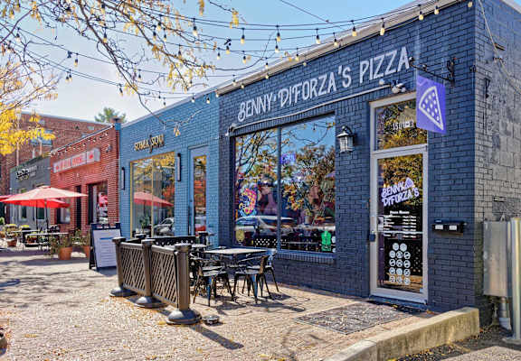 A pizza shop named Benny Diforza's Pizza is shown with outdoor seating.