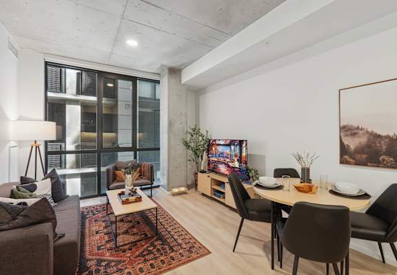 Living room with Dining table and Television at Velaris Living Apartments, Denver, 80205