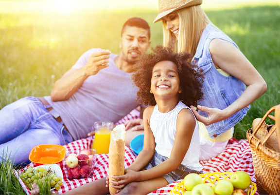 A family having a picnic in a grassy field.