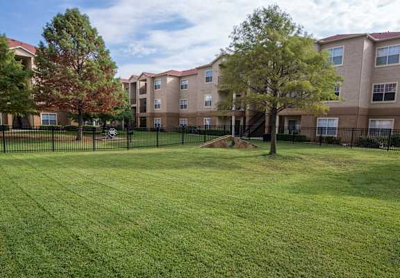 A grassy area in front of apartment buildings. at Infinity on Sunnyvale Apartments , Mesquite, 75150