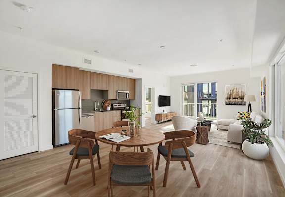 A modern dining room with a wooden table and chairs.at 2221 S Western, Los Angeles, CA 90018