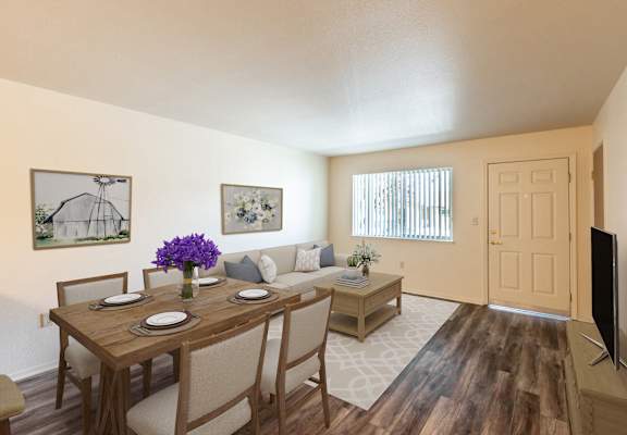 an open living room and dining room with a table and chairs