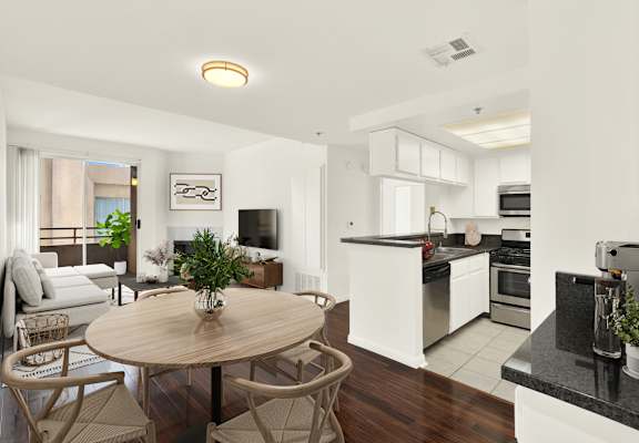 A modern kitchen with a dining table and chairs at Peach Tree Court, Los Angeles, California