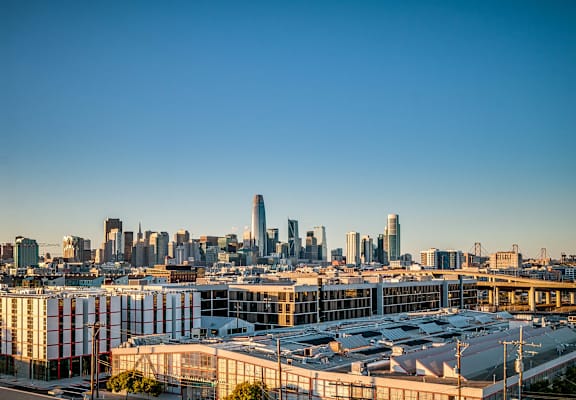 A cityscape with a clear blue sky above it.