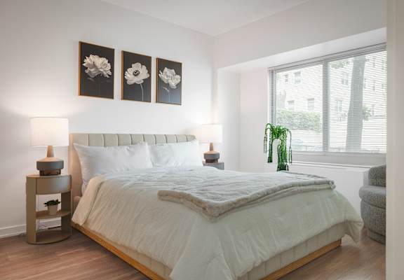 a bedroom with a large bed and a window