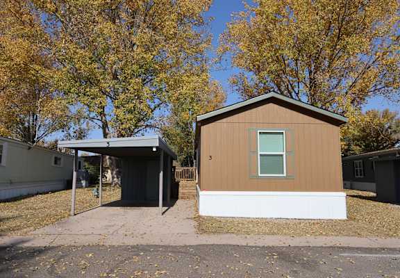 the front of a small house with a garage and trees at Circle Park, Cheyenne, Wyoming