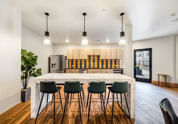 a kitchen with a large island and bar chairs at Northern Lights a Lifestyle-Driven Community, North Dakota