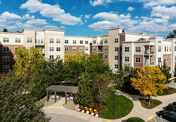 A large apartment complex with a courtyard and trees.