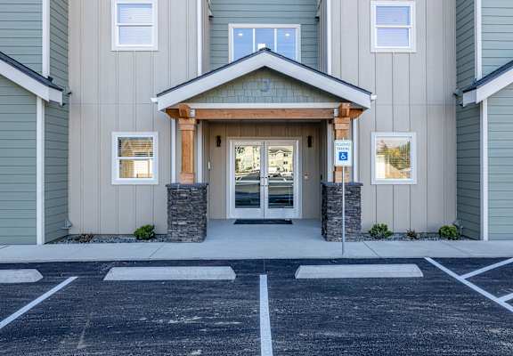 the front entrance of a building with a parking lot at Sagecrest Apartments, Washington, 98801
