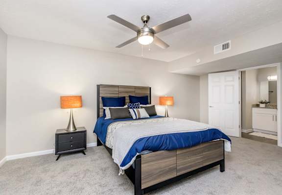 A bedroom with a bed, nightstands, and a ceiling fan at 400 Winchester Apartments, Atlanta, Georgia