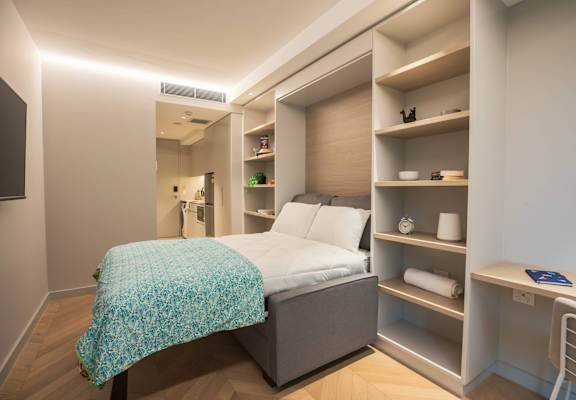 a small bedroom with a bed and a closet