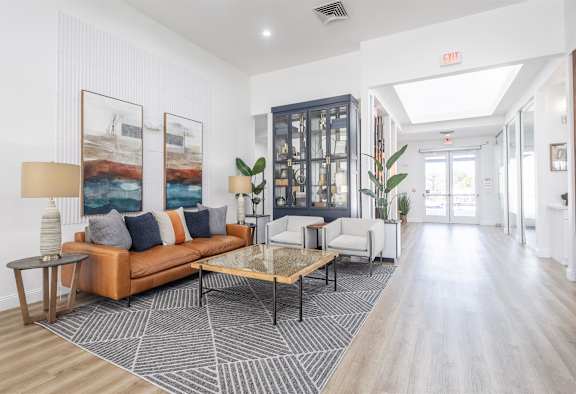 a living room with a leather couch and a coffee table