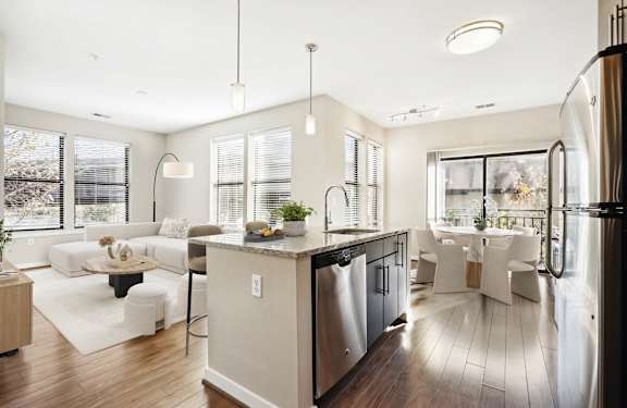 a white living room with a kitchen and a dining room