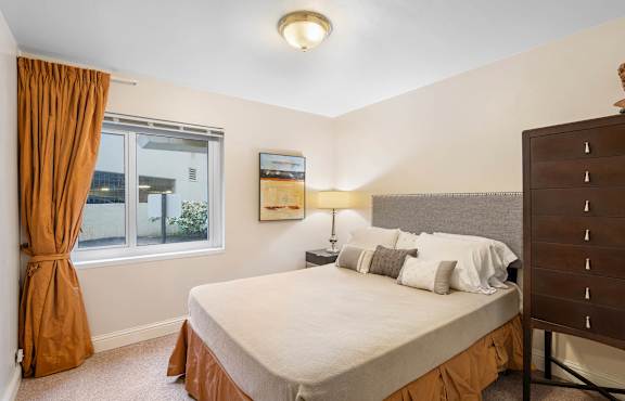 a bedroom with a large bed and a window