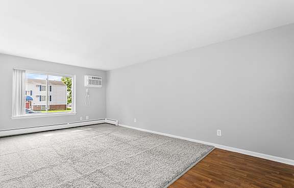 an empty room with a window and a rug at Eagle Pointe New London, CT, 06320
