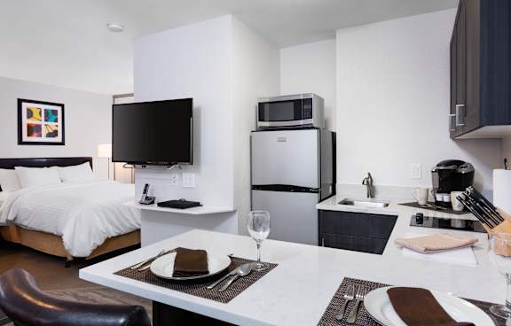 A modern living room with white furniture and a flat screen TV. at The Maddox Sunnyvale, Sunnyvale, 94087