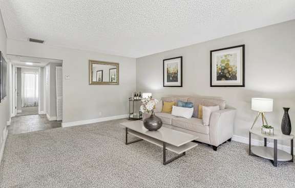 a living room with a couch and a coffee table at Summerwood Apartments, California, 95050