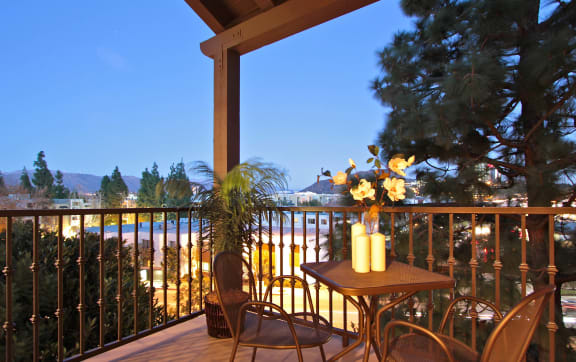 a balcony with a table and chairs and a view of the beach  at L'Estancia, Studio City, California