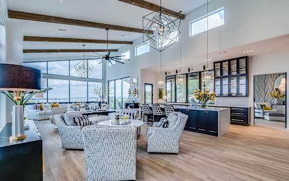 A modern living room with a large window and a ceiling fan.