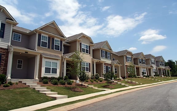 A row of houses with a clear blue sky above them.