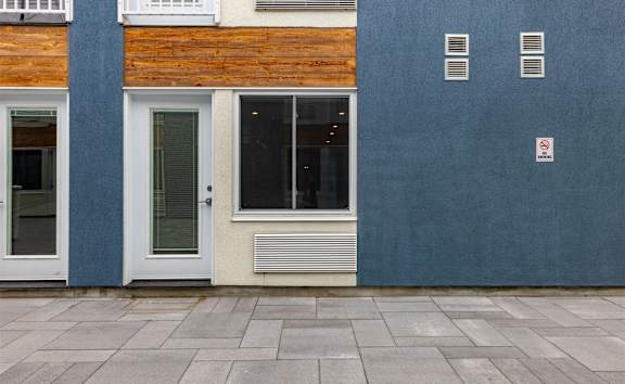 A building with a blue wall and a white door.