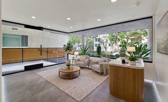 A modern living room with a wooden coffee table and a large window.