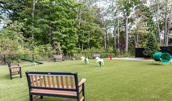 A park with a bench and a playground.