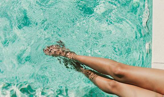 A person's legs are submerged in water.
