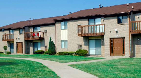 a building with balconies and a sidewalk