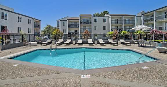a swimming pool in front of an apartment building