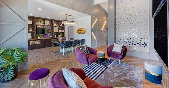 a living room with couches and chairs and a dining room with a bar at Paisley and Pointe Apartments, Las Vegas, 89130